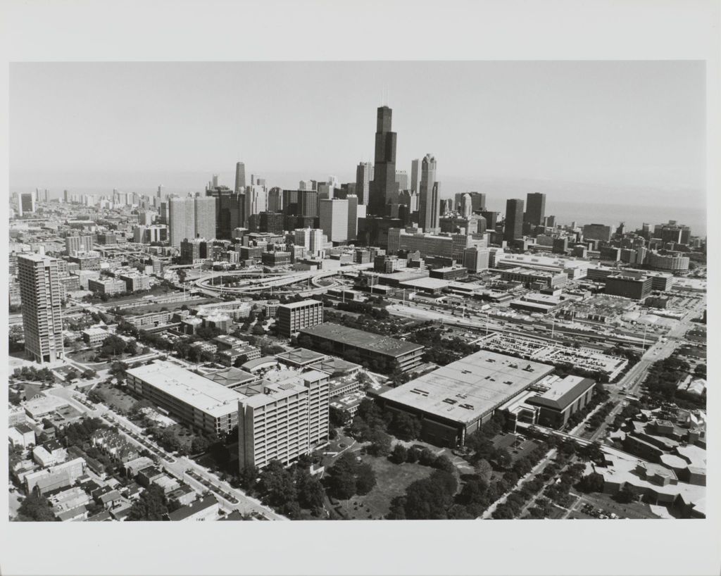 black and white aerial image of UIC East Campus buildings, with downtown Chicago skyline and the lakefront in the background